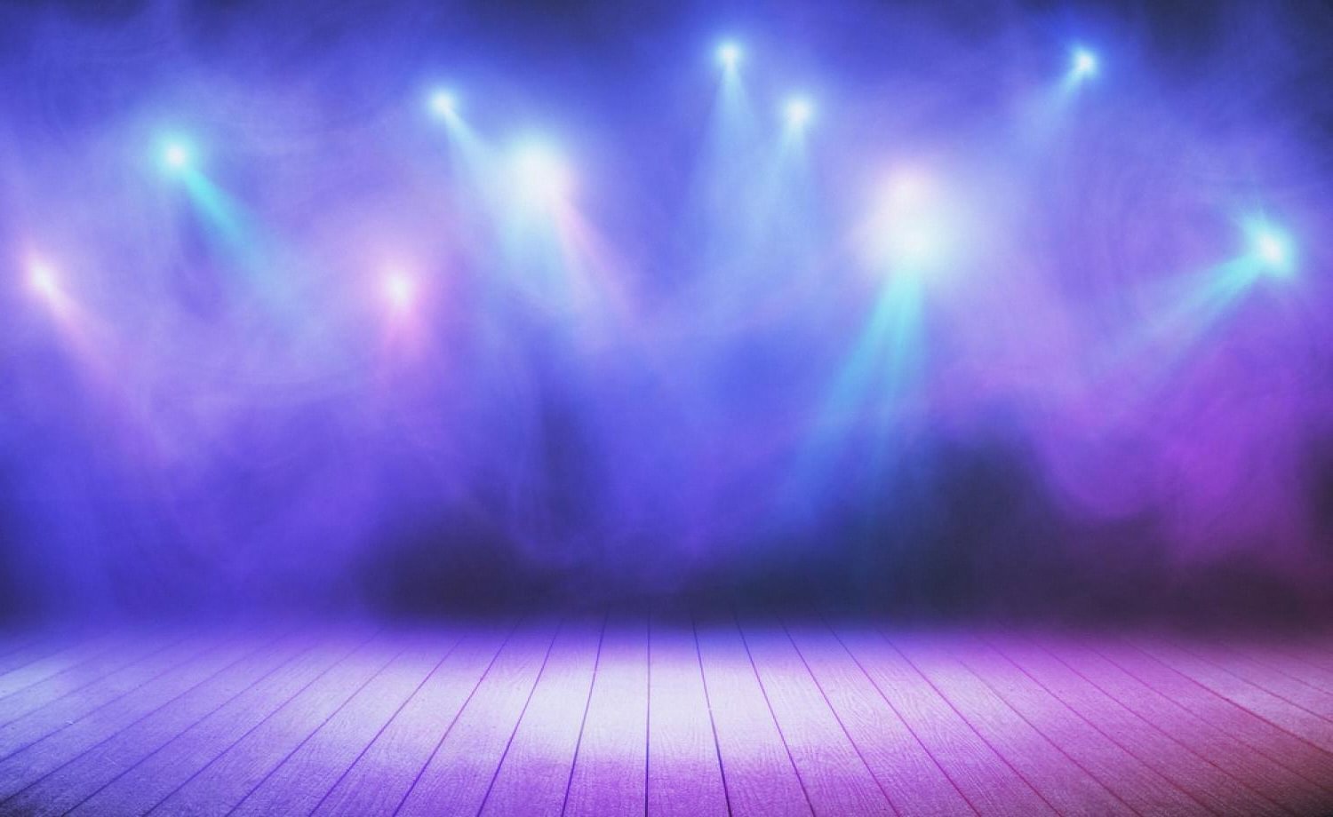 Immersive stage with coloured spotlights and haze ready for an LED wall activation