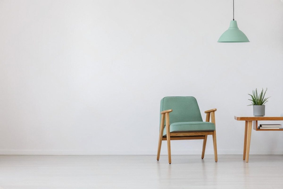Green upholstered armchair and side table showing individual furniture rental options in the UAE