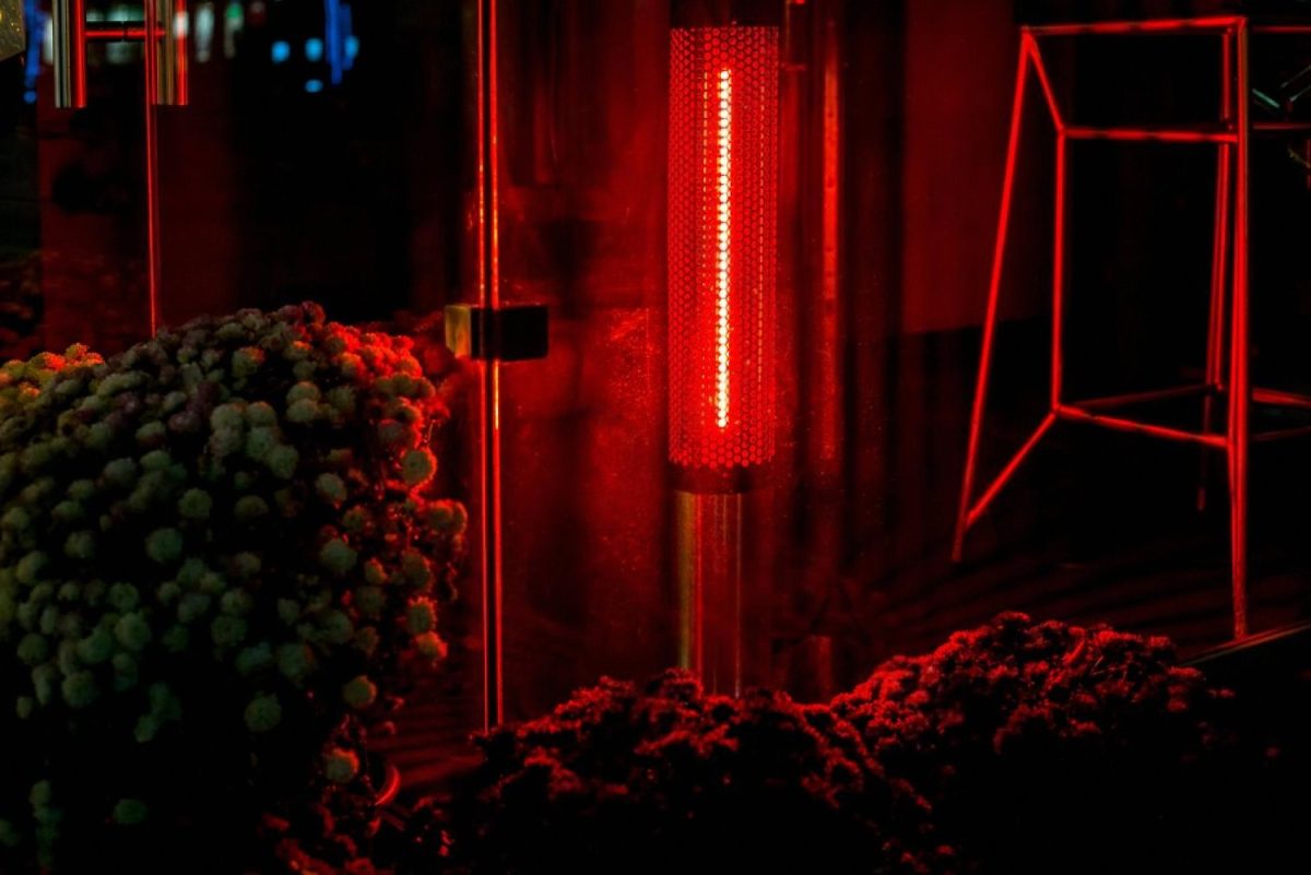 Glowing outdoor gas patio heater warming a restaurant terrace at night in the UAE