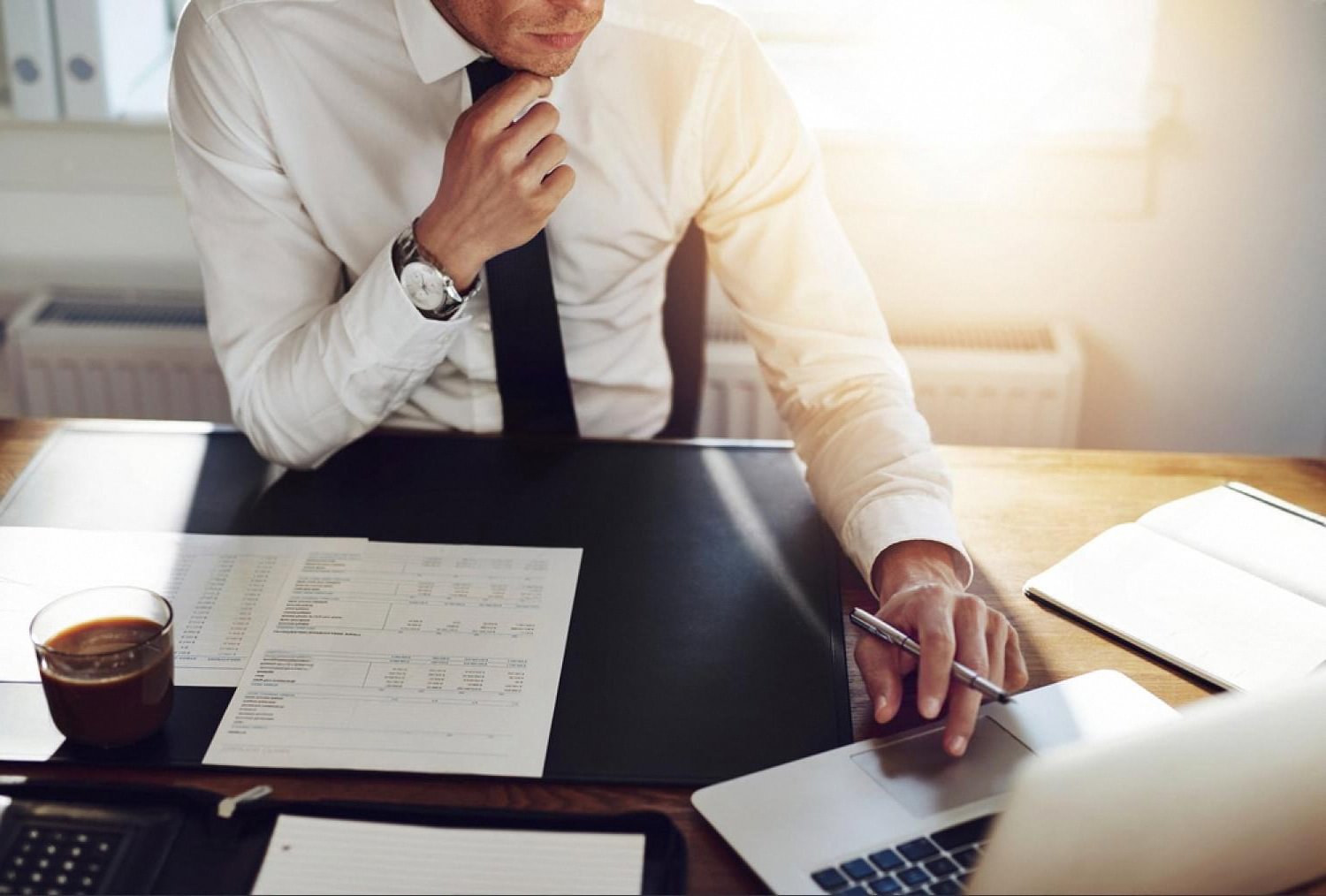 UAE business professional reviewing financial risk reports at an office desk
